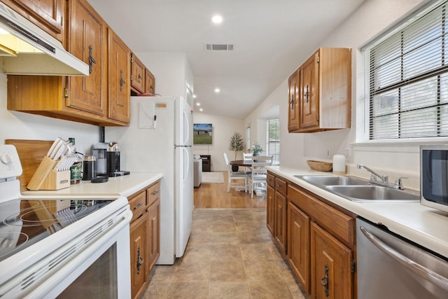 713 Loganwood Dr, Royse City, TX 75189 - kitchen with white appliances, under cabinet range hood, a sink, light countertops, and brown cabinets