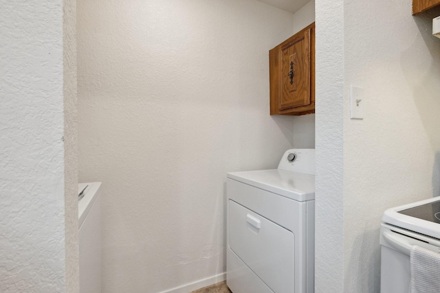 713 Loganwood Dr, Royse City, TX 75189 - laundry room featuring washer / dryer, a textured wall, and cabinet space