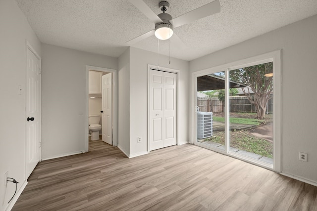 2911 Post Oak Dr, Euless, TX 76039 - unfurnished bedroom with access to exterior, a textured ceiling, wood finished floors, baseboards, and ensuite bathroom