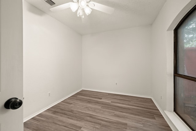 2911 Post Oak Dr, Euless, TX 76039 - unfurnished room featuring wood finished floors, ceiling fan, baseboards, and a textured ceiling