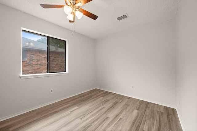 2911 Post Oak Dr, Euless, TX 76039 - unfurnished room with wood finished floors, a ceiling fan, a textured ceiling, and baseboards