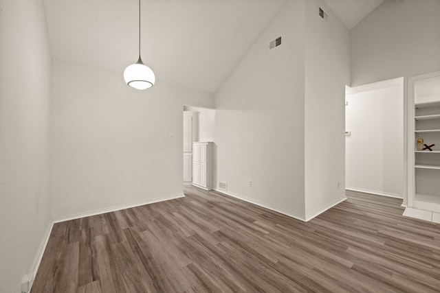 2911 Post Oak Dr, Euless, TX 76039 - unfurnished dining area featuring wood finished floors, high vaulted ceiling, and baseboards