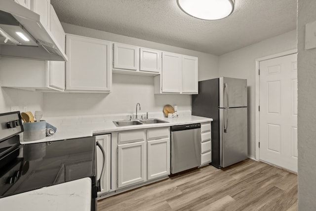 2911 Post Oak Dr, Euless, TX 76039 - kitchen with appliances with stainless steel finishes, a sink, under cabinet range hood, white cabinets, and light wood-style floors