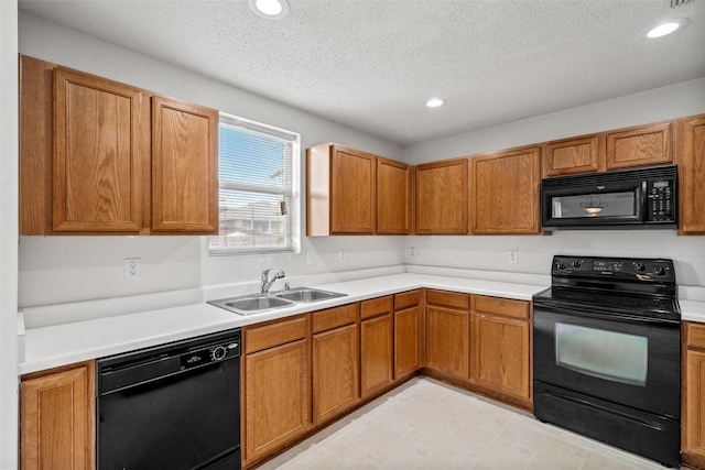 16616 Jasmine Springs Dr, Fort Worth, TX 76247 - kitchen with black appliances, a sink, a textured ceiling, light countertops, and brown cabinetry