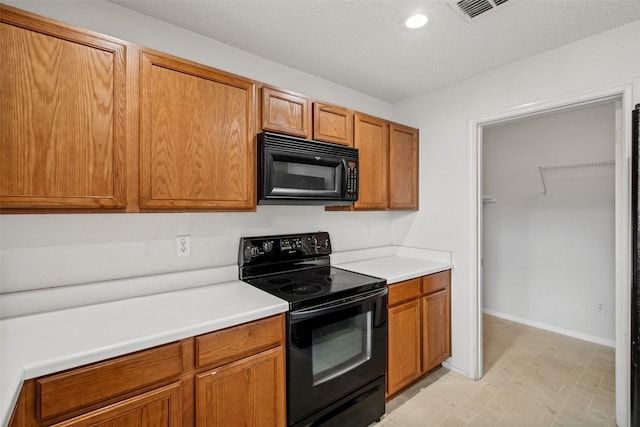 16616 Jasmine Springs Dr, Fort Worth, TX 76247 - kitchen featuring black appliances, baseboards, light countertops, brown cabinetry, and recessed lighting