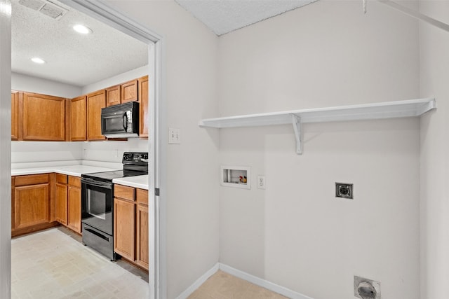 16616 Jasmine Springs Dr, Fort Worth, TX 76247 - kitchen featuring black appliances, a textured ceiling, light countertops, recessed lighting, and brown cabinets