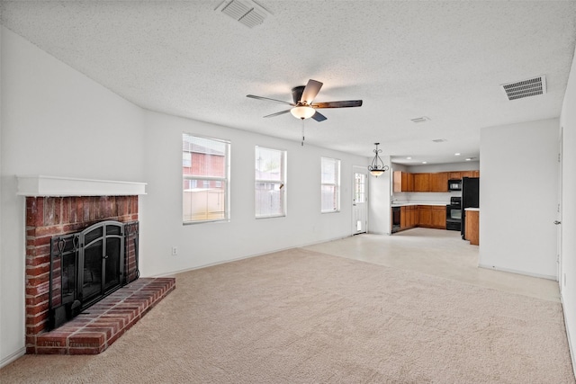 16616 Jasmine Springs Dr, Fort Worth, TX 76247 - unfurnished living room featuring a brick fireplace, ceiling fan, light carpet, and a textured ceiling