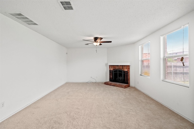 16616 Jasmine Springs Dr, Fort Worth, TX 76247 - unfurnished living room featuring carpet, a brick fireplace, a textured ceiling, a ceiling fan, and baseboards