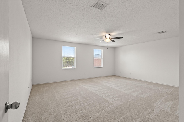 16616 Jasmine Springs Dr, Fort Worth, TX 76247 - empty room with light carpet, a ceiling fan, and a textured ceiling