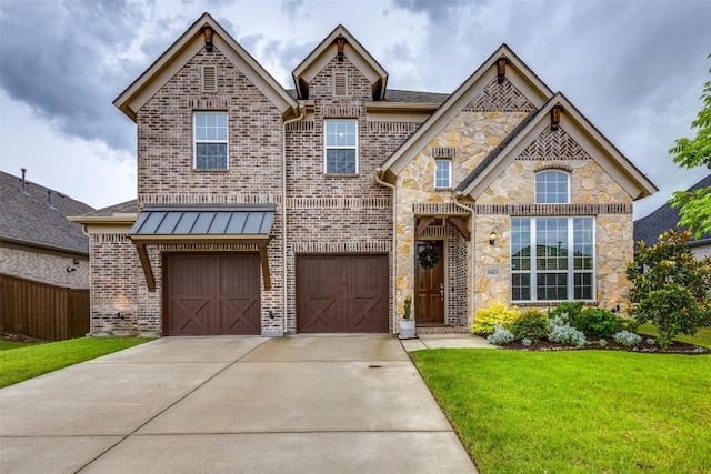 1421 Benavites Dr, Little Elm, TX 75068 - view of front of house featuring driveway, a front yard, brick siding, an attached garage, and stone siding