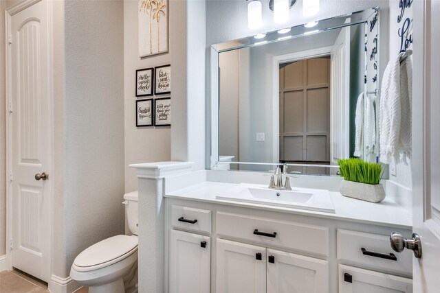 1421 Benavites Dr, Little Elm, TX 75068 - bathroom featuring toilet, vanity, and a textured wall