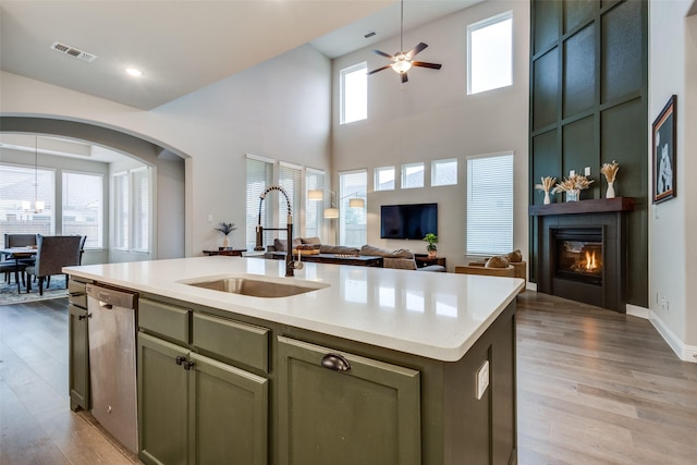 1421 Benavites Dr, Little Elm, TX 75068 - kitchen featuring a sink, a fireplace, dishwasher, open floor plan, and light wood finished floors