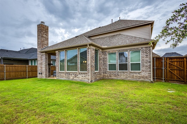 1421 Benavites Dr, Little Elm, TX 75068 - back of property with brick siding, a shingled roof, a chimney, and a gate