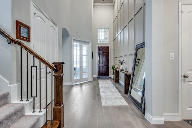 1421 Benavites Dr, Little Elm, TX 75068 - entryway with stairway, wood finished floors, a towering ceiling, french doors, and baseboards