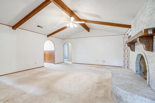 502 Roaring Springs Dr, Joshua, TX 76058 - unfurnished living room featuring a ceiling fan, arched walkways, a fireplace, a textured ceiling, and carpet floors