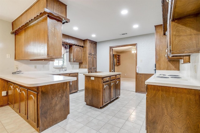 502 Roaring Springs Dr, Joshua, TX 76058 - kitchen featuring a kitchen island, light countertops, a peninsula, recessed lighting, and brown cabinetry