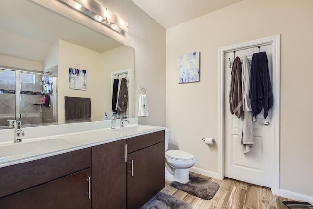 3446 Kirby Ln, Forney, TX 75126 - bathroom featuring double vanity, a shower stall, toilet, baseboards, and wood finished floors