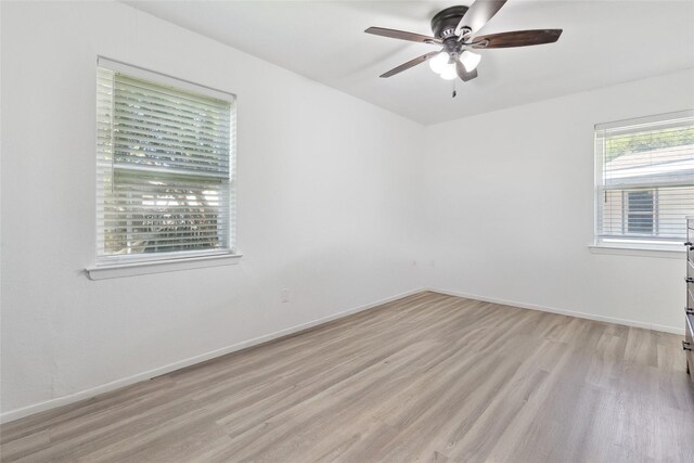 2425 Misty Ln, Carrollton, TX 75006 - spare room with light wood-type flooring, ceiling fan, and baseboards
