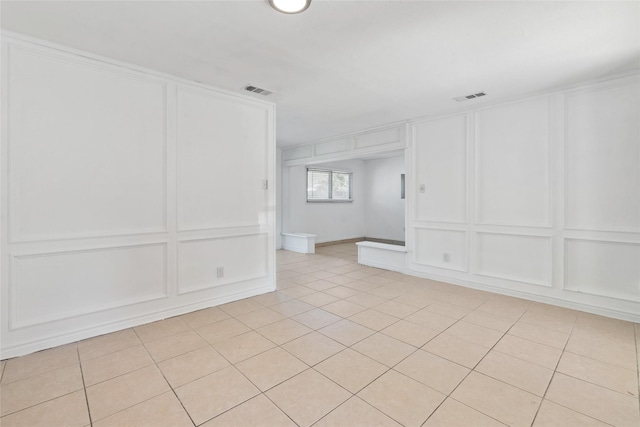 2425 Misty Ln, Carrollton, TX 75006 - empty room featuring a decorative wall and light tile patterned floors
