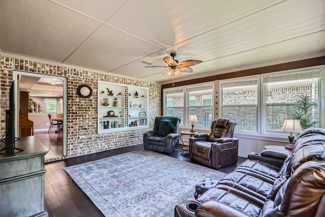 8745 Twin Pines Ln, Frisco, TX 75036 - living area with ceiling fan, wood-type flooring, brick wall, and crown molding