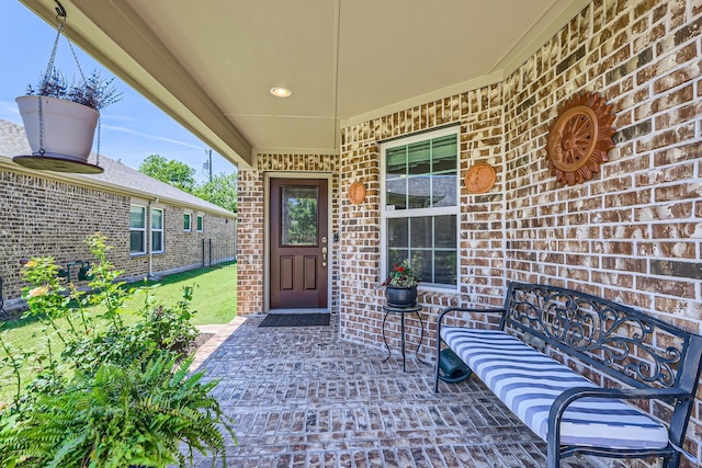 8745 Twin Pines Ln, Frisco, TX 75036 - view of exterior entry with brick siding and a lawn