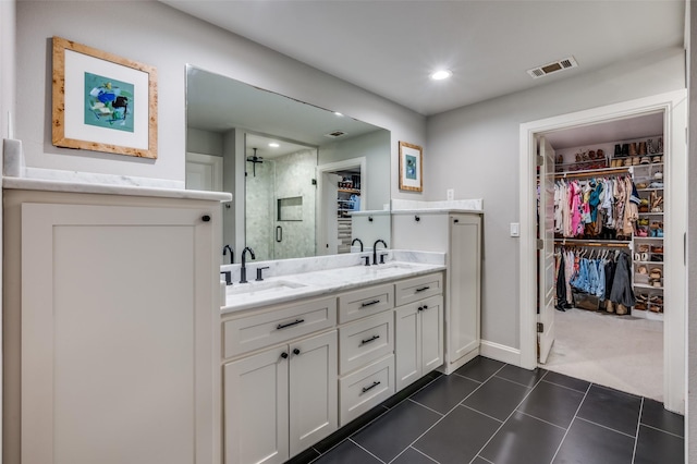 4017 Piedmont Rd, Fort Worth, TX 76116 - bathroom featuring a walk in closet, a stall shower, double vanity, tile patterned floors, and recessed lighting