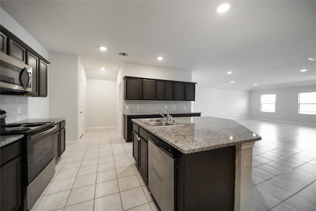 708 Rustic Meadows Trl, Princeton, TX 75407 - kitchen featuring appliances with stainless steel finishes, a sink, light tile patterned floors, recessed lighting, and open floor plan