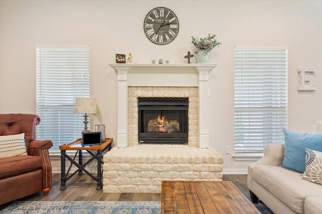 713 Tahoe Trl, Hewitt, TX 76643 - living area with wood finished floors, a brick fireplace, and baseboards