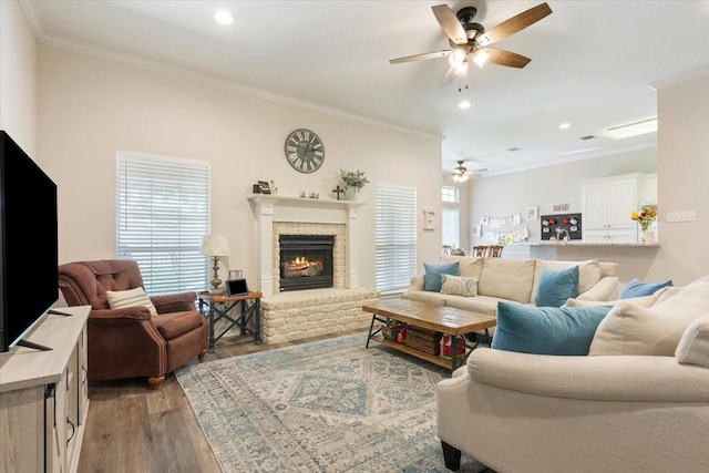 713 Tahoe Trl, Hewitt, TX 76643 - living room featuring ceiling fan, crown molding, light wood-type flooring, a brick fireplace, and recessed lighting