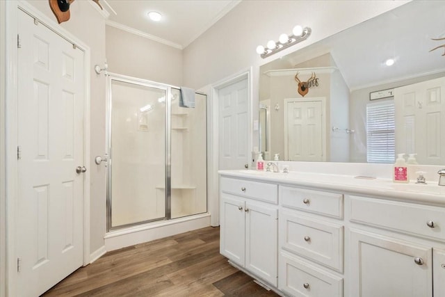 713 Tahoe Trl, Hewitt, TX 76643 - full bathroom featuring ornamental molding, a shower stall, double vanity, and wood finished floors