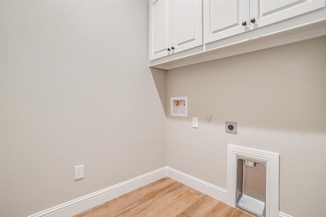 8732 Fullerton Dr, Cleburne, TX 76033 - washroom featuring electric dryer hookup, cabinet space, washer hookup, light wood-style flooring, and baseboards