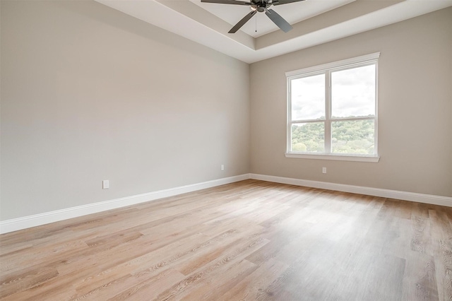 8732 Fullerton Dr, Cleburne, TX 76033 - empty room featuring light wood-style flooring, baseboards, a tray ceiling, and ceiling fan