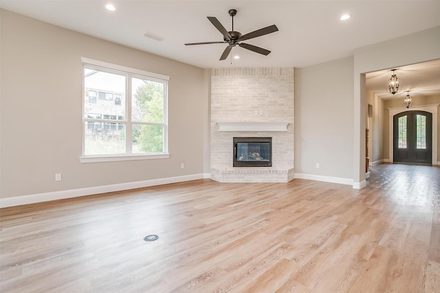 8732 Fullerton Dr, Cleburne, TX 76033 - unfurnished living room with light wood finished floors, baseboards, recessed lighting, a ceiling fan, and a brick fireplace