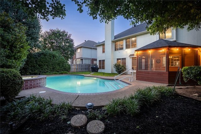 7705 Marble Canyon Ct, Fort Worth, TX 76137 - view of swimming pool with a sunroom, an in-ground hot tub, and a patio area