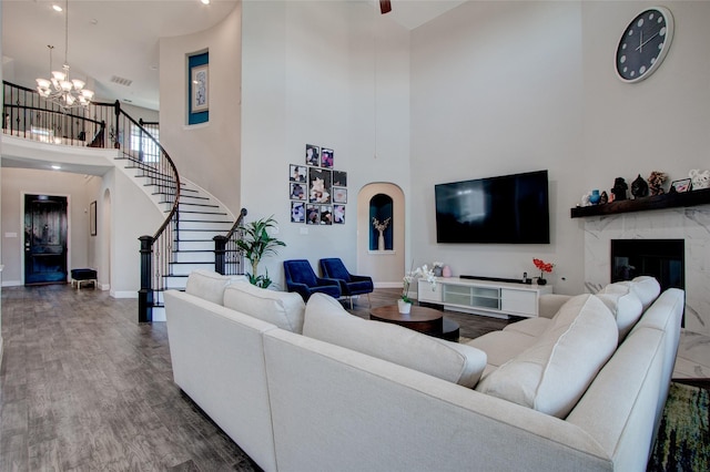 12990 Twelve Oaks Ave, Frisco, TX 75035 - living room with a towering ceiling, a chandelier, stairs, baseboards, and wood finished floors