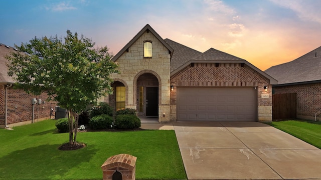 11913 Bellegrove Rd, Burleson, TX 76028 - french country home with an attached garage, brick siding, stone siding, concrete driveway, and a front lawn