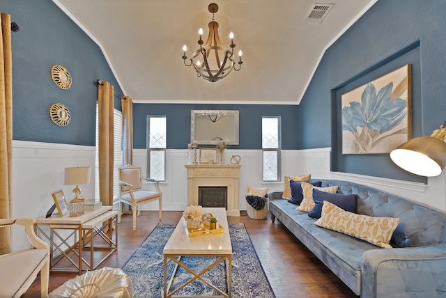 11913 Bellegrove Rd, Burleson, TX 76028 - living room with vaulted ceiling, a wainscoted wall, wood finished floors, a chandelier, and crown molding