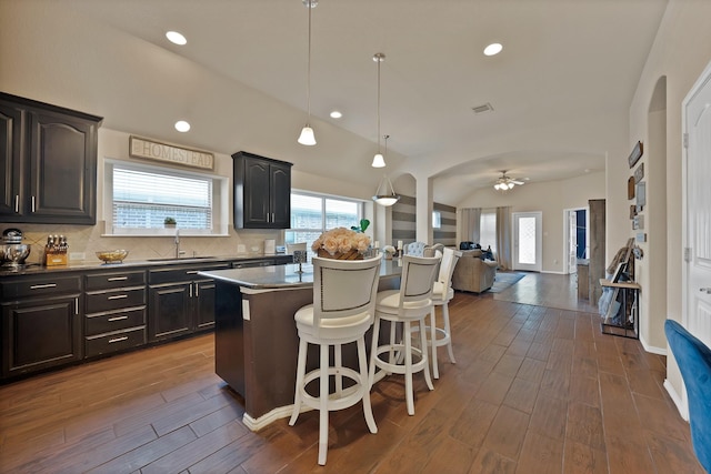 11913 Bellegrove Rd, Burleson, TX 76028 - kitchen with a sink, a kitchen bar, a center island, ceiling fan, and dark wood-type flooring