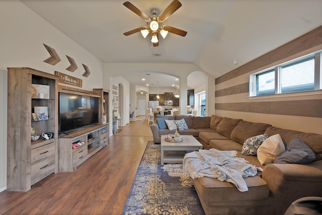 11913 Bellegrove Rd, Burleson, TX 76028 - living room with arched walkways, a ceiling fan, wood finished floors, and vaulted ceiling