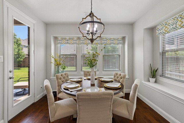 2851 Clearwater Dr, Prosper, TX 75078 - dining area with a chandelier, dark wood finished floors, and healthy amount of natural light