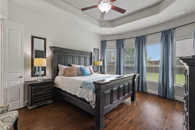 2851 Clearwater Dr, Prosper, TX 75078 - bedroom featuring a raised ceiling, dark wood-type flooring, baseboards, and a ceiling fan