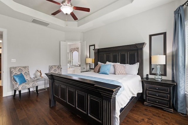 2851 Clearwater Dr, Prosper, TX 75078 - bedroom with a raised ceiling, dark wood-style flooring, and a ceiling fan