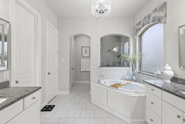 2851 Clearwater Dr, Prosper, TX 75078 - bathroom featuring a bath, two vanities, tile patterned flooring, a chandelier, and tiled shower
