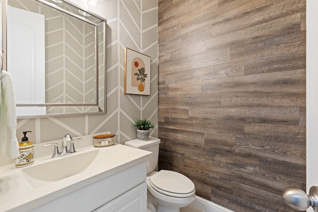 2851 Clearwater Dr, Prosper, TX 75078 - half bath featuring toilet, vanity, and wooden walls