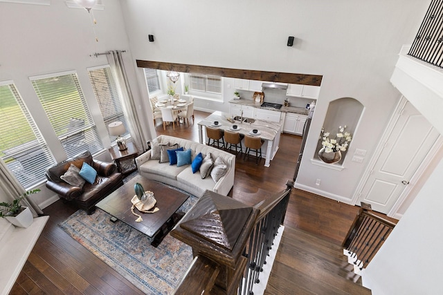 2851 Clearwater Dr, Prosper, TX 75078 - living area with a high ceiling, dark wood finished floors, and baseboards