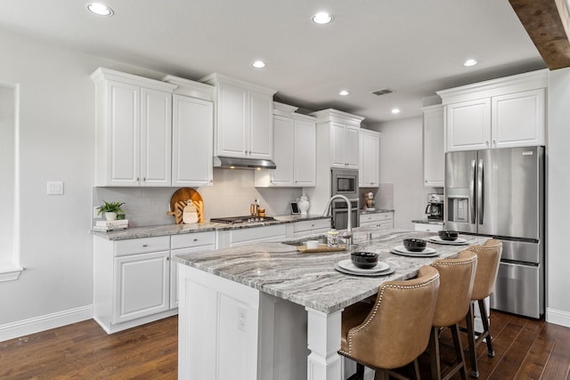 2851 Clearwater Dr, Prosper, TX 75078 - kitchen featuring appliances with stainless steel finishes, a sink, dark wood finished floors, under cabinet range hood, and recessed lighting