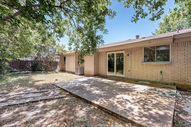 1723 Overbrook Dr, Arlington, TX 76014 - rear view of house featuring brick siding, a patio, and central AC
