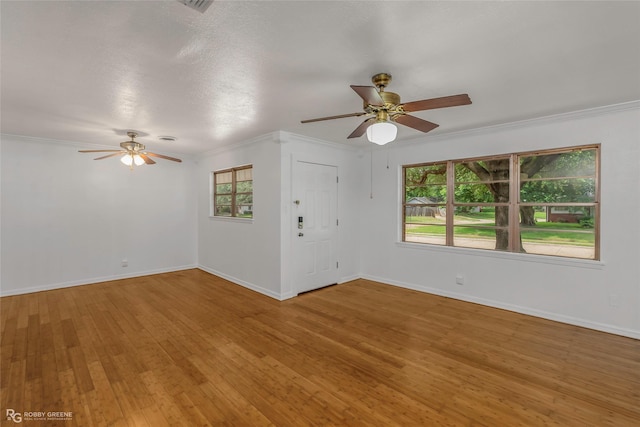 2932 W Cavett Dr, Shreveport, LA 71104 - empty room with ceiling fan, wood finished floors, baseboards, and ornamental molding