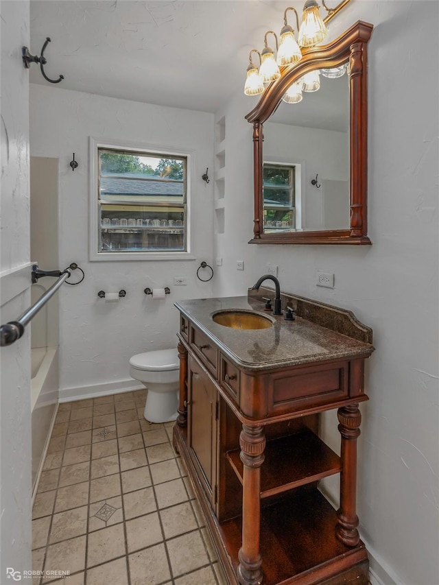 2932 W Cavett Dr, Shreveport, LA 71104 - bathroom with toilet, a chandelier, vanity, a bath, and baseboards