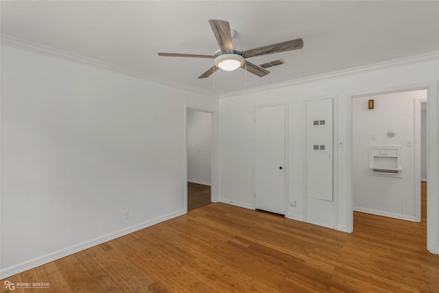 2932 W Cavett Dr, Shreveport, LA 71104 - unfurnished bedroom featuring wood finished floors, crown molding, baseboards, and ceiling fan